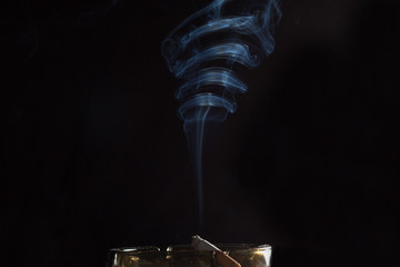 smoke from a cigarette on an ashtray