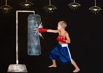 Boy boxer hits a punching bag.Drawings in chalk on the wall.