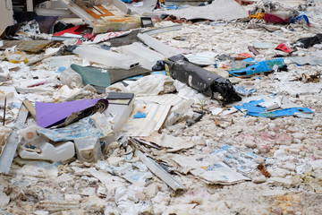 Stack of trash scattered on the floor in an abandoned building