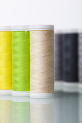 Sewing equipment and  threads on white background.