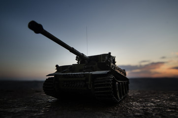 War Concept. Military silhouettes fighting scene on war fog sky background, World War German Tanks Silhouettes Below Cloudy Skyline At night. Attack scene. Armored vehicles. Tanks battle scene