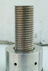 Stainless steel screw thread, architectural detail of an anchor point on a modern bridge construction in the UK.