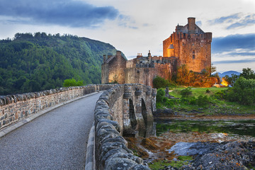 Eilean Donan Castle, Scotland, reflecting itself into the water during evening. - 169334618