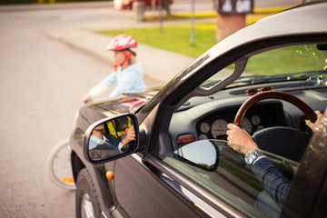 Accident. Girl on the bicycle crosses the road in front of a car