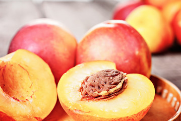 Naklejka na ściany i meble Fresh ripe nectarine peach fruit, crop rustic background