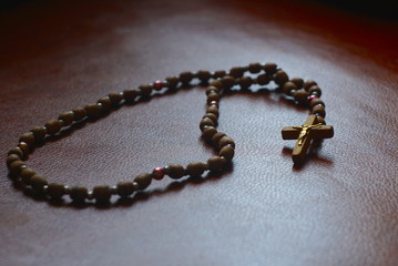 The rosary on a leather sofa, close