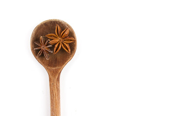 ANISE. ISOLATED SPICE ON WOODEN SPOON ON WHITE BACKGROUND
