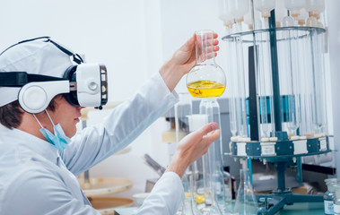 Science technician in virtual reality glasses examines the drug in laboratory.