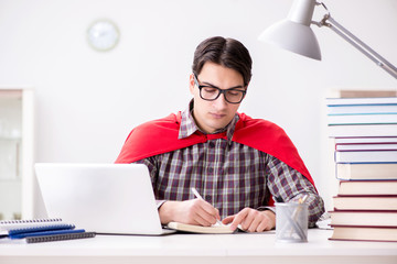 Super hero student with a laptop studying preparing for exams