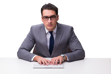 Young businessman typing on a keyboard isolated on white backgro