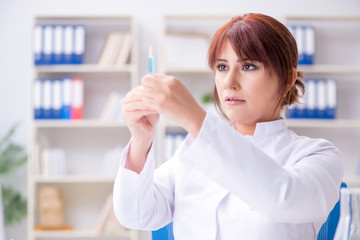 Female scientist researcher conducting an experiment in a labora