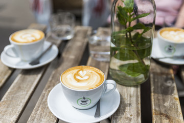 three coffee on wooden table