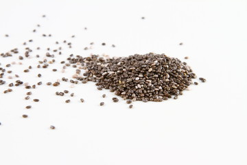 ISOLATED DIFFUSED CHIA SEED IN PILE ON WHITE BACKGROUND