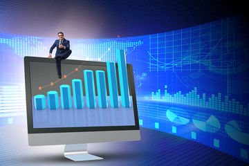 Businessman in economic forecasting concept with charts