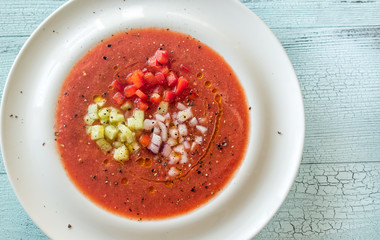 Portion of gazpacho on the wooden table