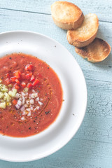 Portion of gazpacho on the wooden table