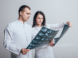 Doctors attentively examines the MRI scan of the patient.