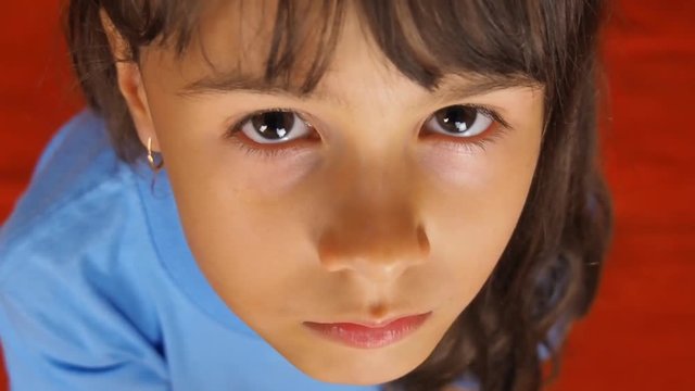 Sad face of a child close-up. Face of a little girl close-up.