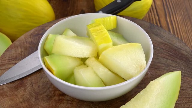 Honeydew Melon on a rotating wooden plate (seamless loopable; 4K)