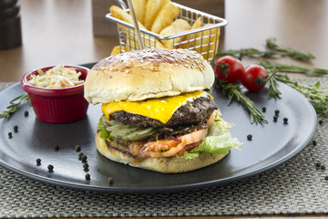 cheese burger with french fries and sauce on plate