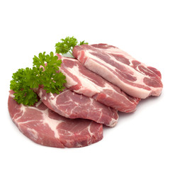 Raw pork neck chop meat with parsley herb leaves garnish isolated on white background cutout