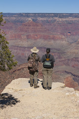 Fototapeta premium A pair of adventurers standing at the Grand Canyon national park, Arizona, USA.