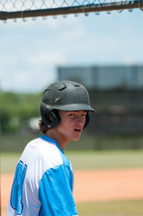 Fototapeta na wymiar Serious high school baseball player in dugout