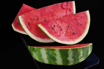Slices of watermelon on black background