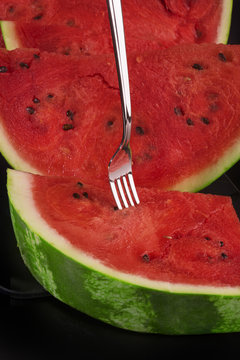 Slices of watermelon on black background