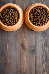 large bowl of pet - dog food on wooden background top view mockup
