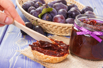 Preparing sandwiches with homemade plum marmalade or jam, sweet breakfast or dessert concept