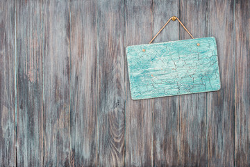 Signboard blank on vintage old grunge wooden wall planks texture background. Retro style filtered photo