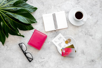 Pay restaurant bill. Bill, bank card, wallet, coins near cup of coffee on light stone table top view