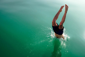 Diving and jumping from a boat at Balaton lake in Hungary