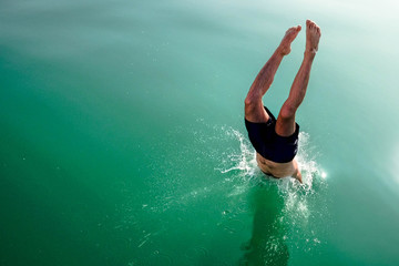 Diving and jumping from a boat at Balaton lake in Hungary