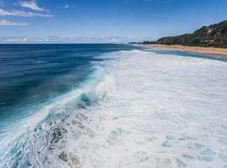 Aerial view of a big breaking wave on the north shore of Oahu Hawaii