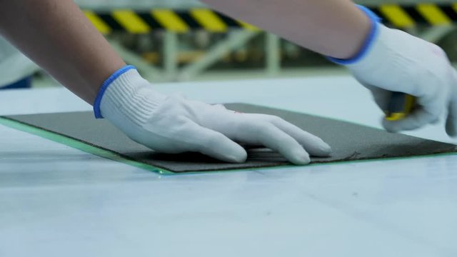hand cutting plastic sheets with a cuter