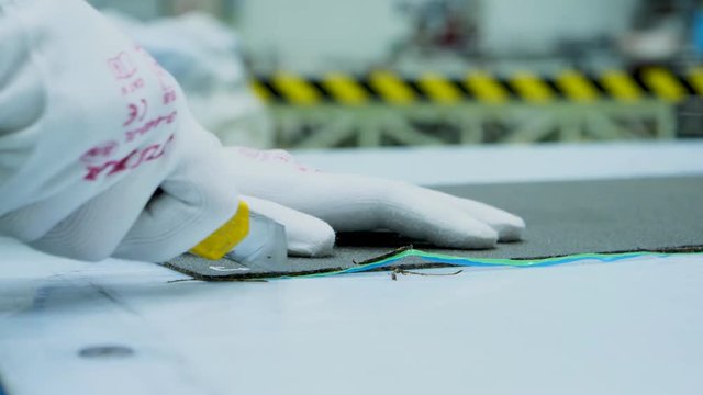 hand cutting plastic sheets with a cuter