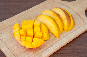 Mango sliced lying on a wooden board
