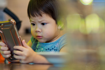 child addicted phone. asian boy playing smartphone / kid use telephone