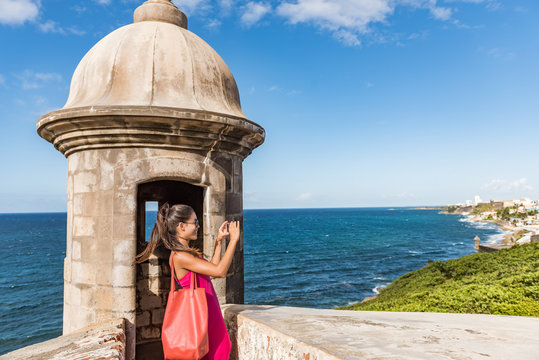 Puerto Rico San Juan woman taking phone pictures of Old San Juan Fort Castillo San Felipe Del Morro. Asian tourist people traveling in the USA visiting famous latin american landmark.