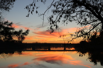 Fototapeta na wymiar Orange Sunset over Water