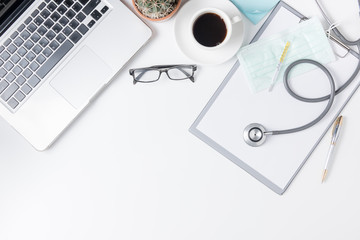 Top view of doctor desk table with stethoscope