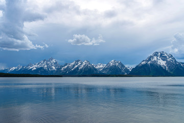 Stormy Mountain Lake - Spring afternoon storm clouds moving over Jackson Lake, with Teton Range rising in the background, Grand Teton National Park, Wyoming, USA. 
