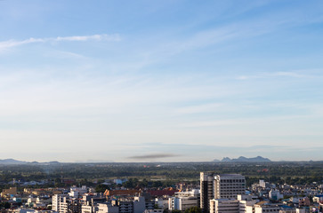 Buildings, forests, mountains, sky.