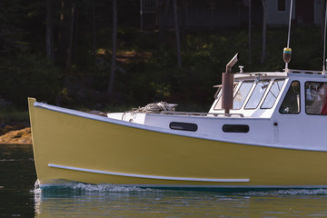Lobster boat heads out for a beautiful days work in South Bristol, Maine, United States