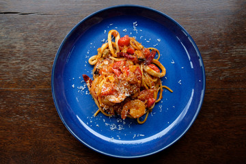 spaghetti seafood tomato sauce on wood table