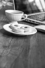 Top view home office table with laptop, coffee and cookie on wooden table. Modern office top view at home. New life style. Concept : business and office.