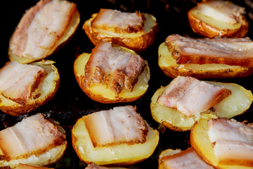 Baked potatoes grilled on skewers. Street festival food.
