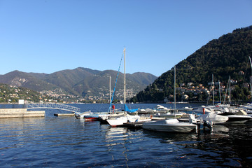 Fototapeta na wymiar Boats along the coast in Lenno, Como lake, Italy. Beautiful touristic place